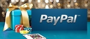 Het PayPal-logo naast een geschenk, speelkaarten en fiches in een casino